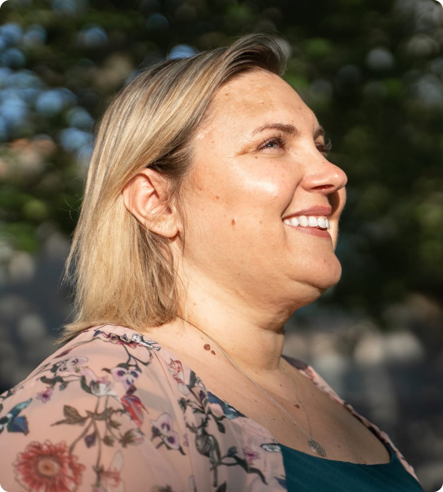 Woman with the sun on her face, smiling