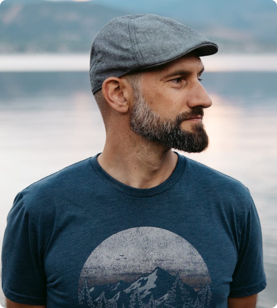 Man with a cap on, looking to the side