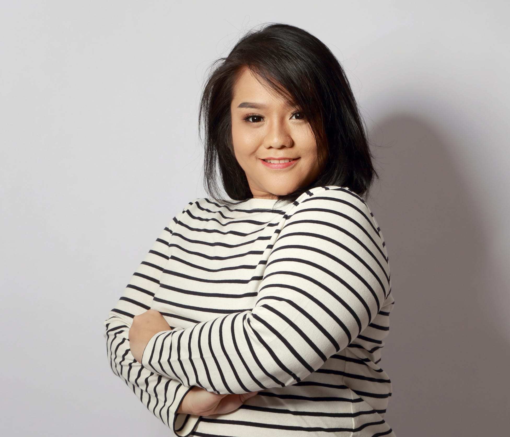 Woman smiling with arms crossed