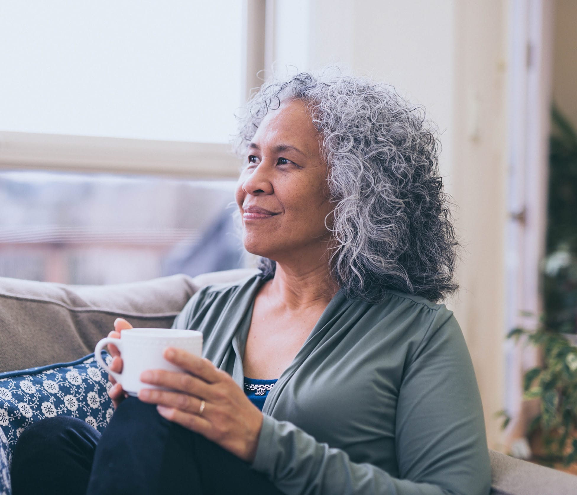 Woman smiling and holding tea